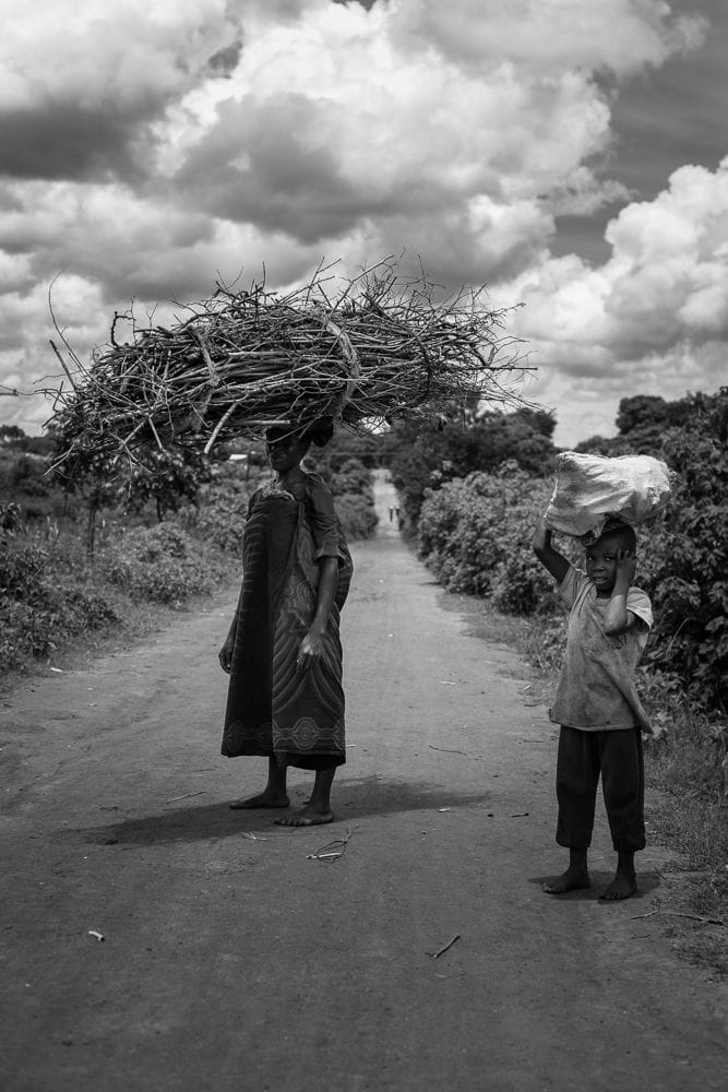 Woman carrying firewood, and her childs